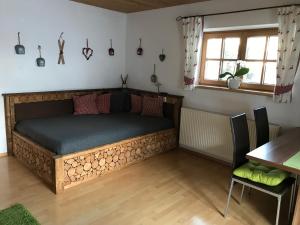 a bed with a wooden frame in a room at Apart Lisi in Fügenberg