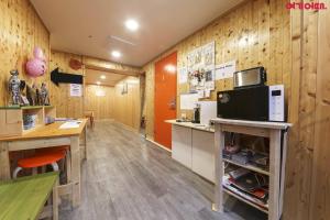 eine Küche mit Holzwänden und einer Theke mit einer Mikrowelle in der Unterkunft Seoul Station R Guesthouse in Seoul