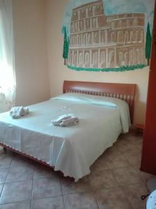 a bed with two towels on top of it at B&B melody in Fiumicino