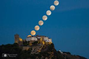 phases of the moon over a castle on a hill at Casa dos Avós in Villa Nogueira