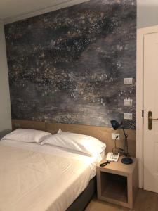 Postel nebo postele na pokoji v ubytování Albergo Tre Pozzi