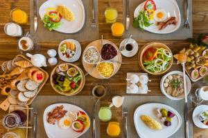 a wooden table with plates of food on it at Acqua Hotel in Pattaya Central