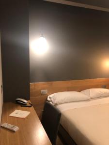 Postel nebo postele na pokoji v ubytování Albergo Tre Pozzi