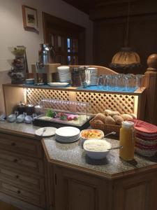 a kitchen counter with plates and food on it at Gasthaus Schützen in Hornberg