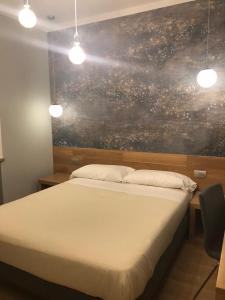 Postel nebo postele na pokoji v ubytování Albergo Tre Pozzi