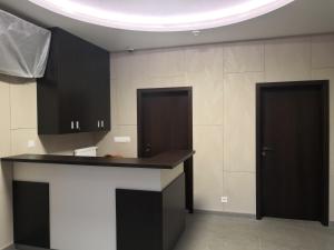 a kitchen with black cabinets and a counter top at Sun-House Pension&Restaurant -ParkingFree- in Prague +93 photos