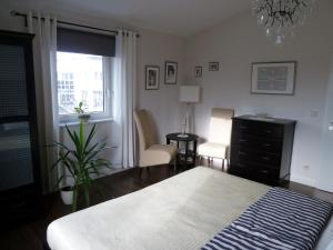 a bedroom with a bed and a dresser and a window at Schedler in Gerbrunn