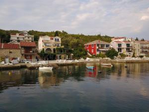 a group of houses and boats in a body of water at Franovic Apartments in Tivat