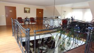 a wrought iron railing in a room with a table at U pani Ani Augustów in Augustów