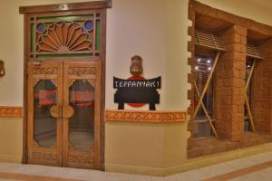 a door to a store with a sign on the wall at Charmillion Sea Life Resort in Sharm El Sheikh