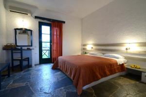 a hotel room with a bed and a window at Vagia Traditional, Aegina Island in Vaia