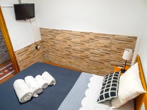 a bedroom with a bed with towels on it at apartamento canarias in La Aldea de San Nicolas