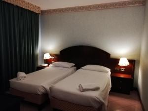 Postel nebo postele na pokoji v ubytování Venice Palace Hotel
