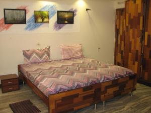 a bedroom with a bed with paintings on the wall at Atithi Comfort Homes (Exclusively for families) - Royal in Visakhapatnam