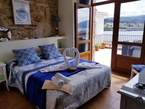 a bedroom with a bed with towels on it at Casa da Balea in Corcubión