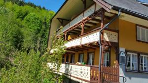a large house with a balcony on the side of it at Antico Mulino Hotel Garni in Todtmoos