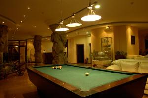a living room with a pool table in it at Elegant Hotel in Bansko