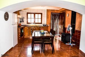 a kitchen with a table and a refrigerator at Casa Rural El Castillo in Chulilla
