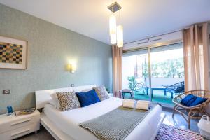 a living room with a white couch and a large window at Sweet Inn - Maison Blanche I in Juan-les-Pins