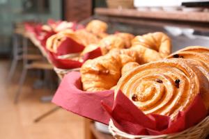 a basket filled with pastries and croissants on a table at Hotel Les Neus in Pas de la Casa