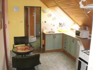 a kitchen with a table and chairs and a sink at Privat Buk 100 in Jindřichŭv Hradec