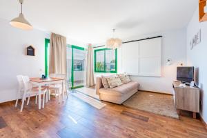 a living room with a couch and a table at Vivienda Vacacional Namana Beach in Costa Teguise