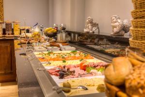 a buffet line with many different types of food at Hotel Zum Bär in Quedlinburg