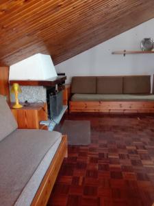 a living room with two beds and a couch at Mansarda condominio Royal in Valtournenche +24 photos