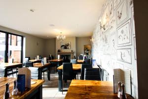 a dining room with wooden tables and chairs at Kings Park Hotel in Retford