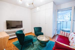 a living room with a couch and chairs and a tv at ☆ Central Apartment with Montreux View ☆ in Montreux
