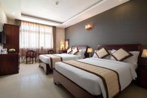 Postel nebo postele na pokoji v ubytování Corvin Hotel