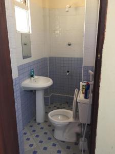 a bathroom with a toilet and a sink at Le Paradis Nyali in Mombasa