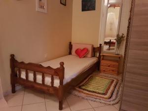 a small bedroom with a bed and a mirror at Kallithea Holiday Homes II in Alykes