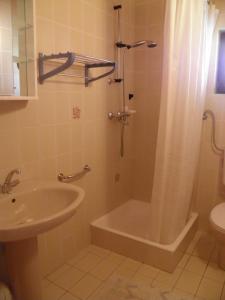 a bathroom with a tub and a sink and a shower at Apartment Roglić in Rab +30 photos