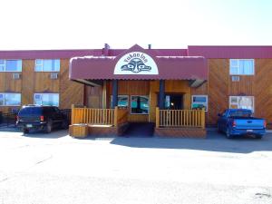 a front view of a restaurant with cars parked outside at The Yukon Inn in Whitehorse