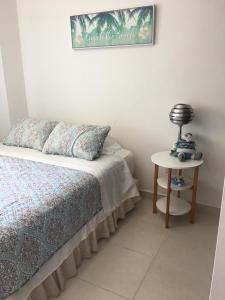 a bedroom with a bed and a lamp on a table at Playa La Barqueta , Las Olas Tower Front in David