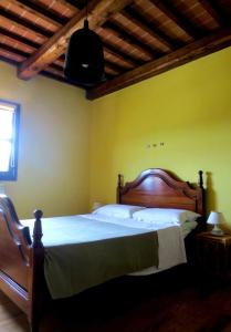 a bedroom with a large bed with a wooden headboard at Apartment with privat garden in Montegabbione
