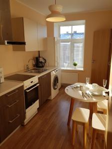 a kitchen with a table and a dining room at Stylish apartment Riga in Rīga