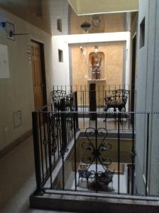 a staircase in a building with black iron railing at Hotel Castellana Inn in Bogotá