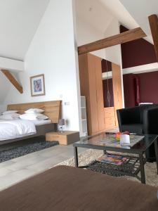 a bedroom with a bed and a coffee table in a room at Hotel Donau in Donauwörth