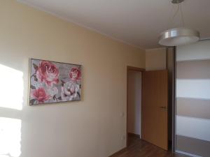 ein Gemälde von Rosen an einer Wand in einem Raum in der Unterkunft Stylish apartment Riga in Riga