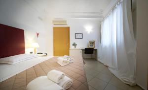 a hotel room with a bed with towels on it at Santuzza Art Hotel Catania in Catania
