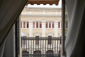 a view of a large building from a window at Santuzza Art Hotel Catania in Catania