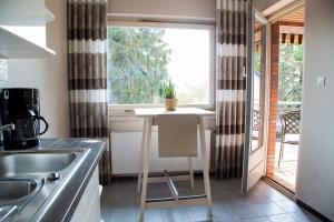 a kitchen with a table in front of a window at Stemweder Quartier in Stemwede
