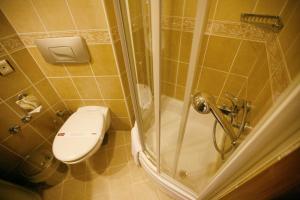 a bathroom with a toilet a sink and a shower at Hotel Uyan-Special Category in Istanbul