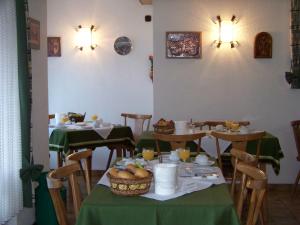 a dining room with tables and chairs with food on them at Pension Milberg Assmannshausen in Rüdesheim am Rhein