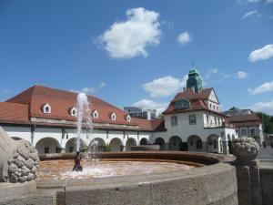 a water fountain in front of a building with a statue at Best Western Hotel Rosenau in Bad Nauheim