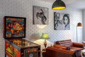a living room with a pinball machine and a couch at Castle Holiday Apartments in Limassol