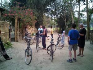 a group of people standing around their bikes at Risong Family Guest House in Majuli