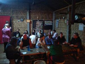 a group of people sitting in a room at Risong Family Guest House in Majuli
